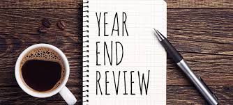 the visual shows a tablet with the words "year end review" with a cup of coffee.  The intent of the article is to review our successes personally and professionally 